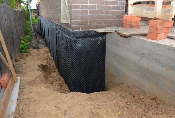 Happy homeowners after waterproofing job in Gambier
